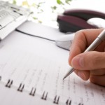Businessman brainstorming and writing notes